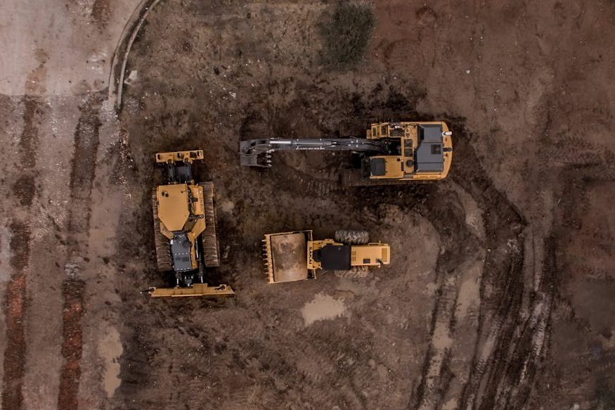 Aerial Photo Of Excavator, Road Roller, And Bulldozer